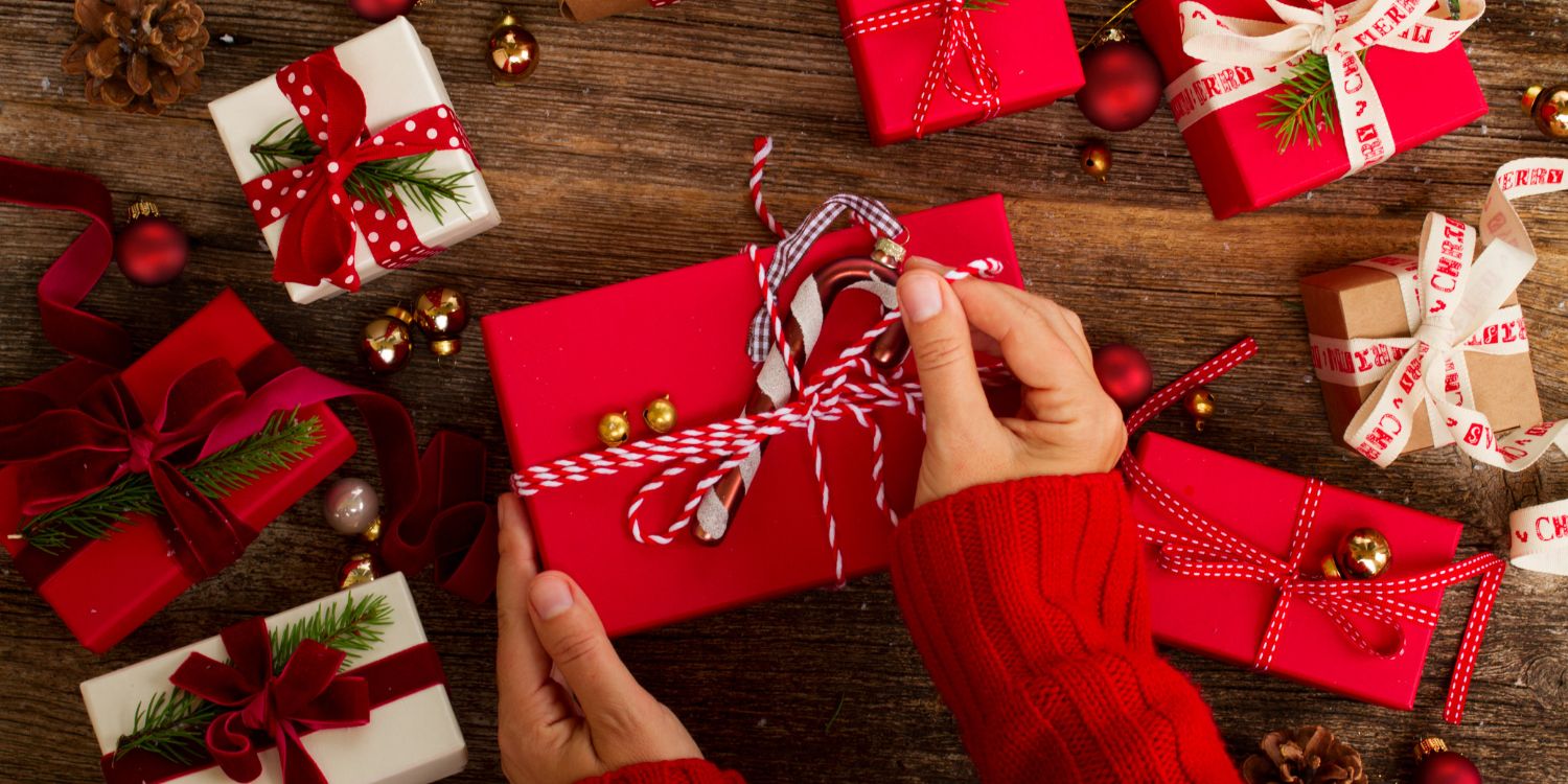 An image of someone wrapping a holiday gift